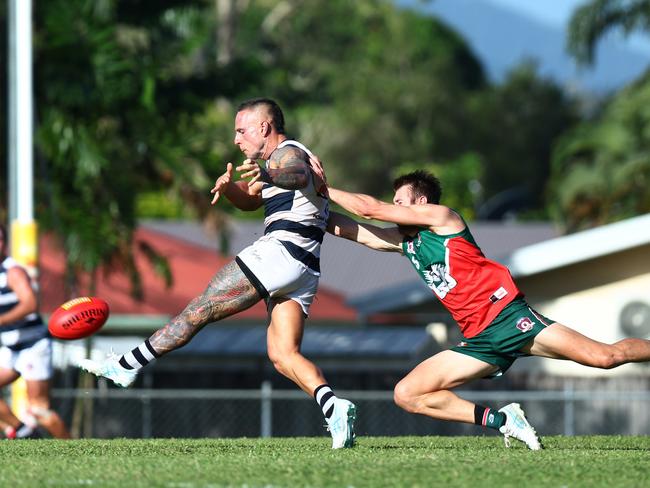 Dillon Walsh-Hall gets a kick away after being chased down by Liam McCarthy in the AFL Cairns senior men's match between the South Cairns Cutters and the Port Douglas Crocs, held at Fretwell Park. Picture: Brendan Radke