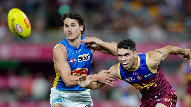 BRISBANE, AUSTRALIA - MAY 05: Wil Powell of the Suns and Charlie Cameron of the Lions in action during the 2024 AFL Round 08 match between the Brisbane Lions and the Gold Coast SUNS at The Gabba on May 05, 2024 in Brisbane, Australia. (Photo by Russell Freeman/AFL Photos via Getty Images)