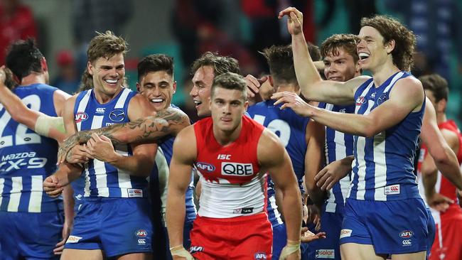 Mason Wood and Ben Brown lead North Melbourne’s celebrations after the siren. Picture: Phil Hillyard