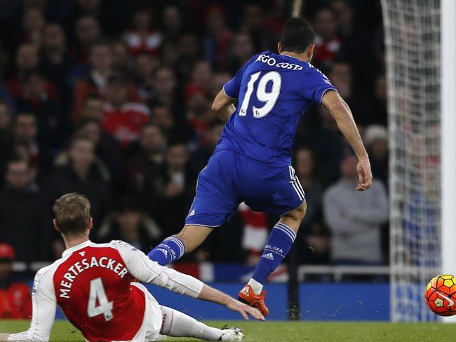 Arsenal's Per Mertesacker, left tackles and fouls Chelsea's Diego Costa.