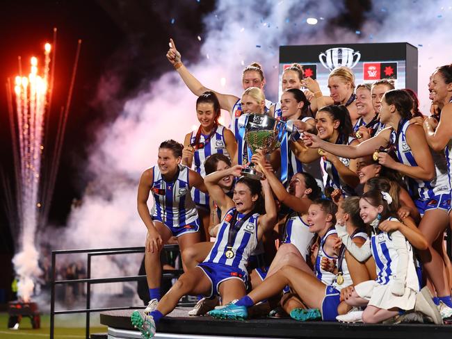 MELBOURNE, AUSTRALIA - NOVEMBER 30: Kangaroos players hold the premiership cup aloft following the AFLW Grand Final match between North Melbourne Tasmanian Kangaroos and Brisbane Lions at Ikon Park, on November 30, 2024, in Melbourne, Australia. (Photo by Morgan Hancock/AFL Photos/via Getty Images) *** BESTPIX ***