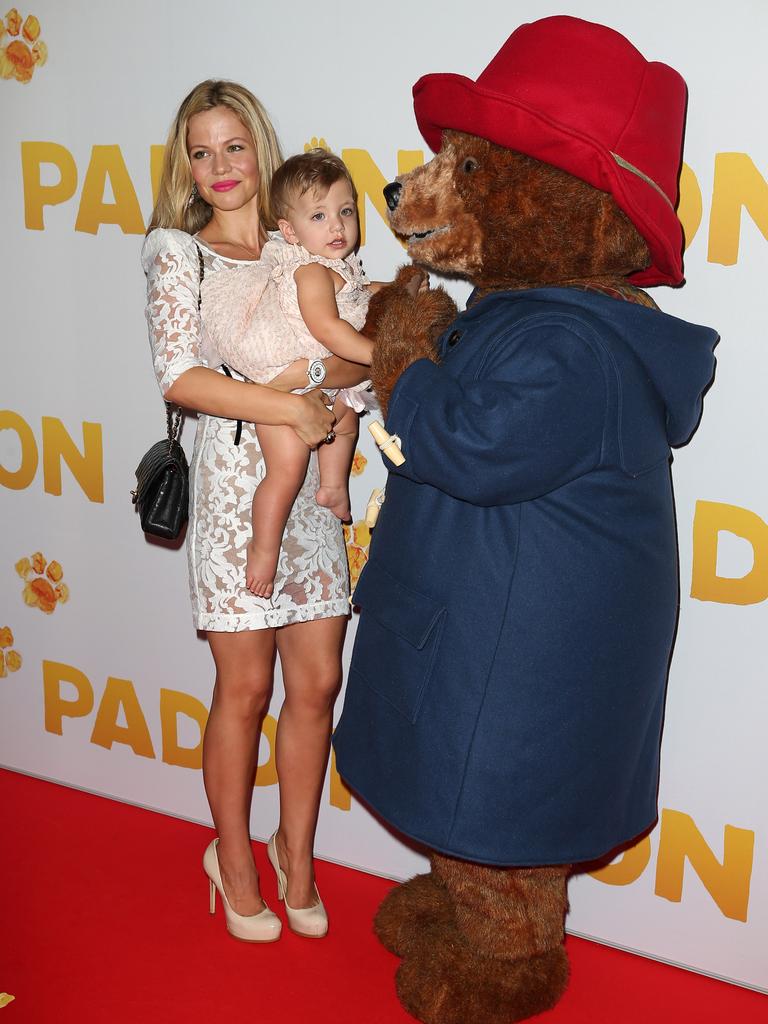 Sursok and Phoenix Emmanuel have a meet and greet with Paddington Bear as they arrive at the Australian premier of Paddington. Picture: Andrew Murray