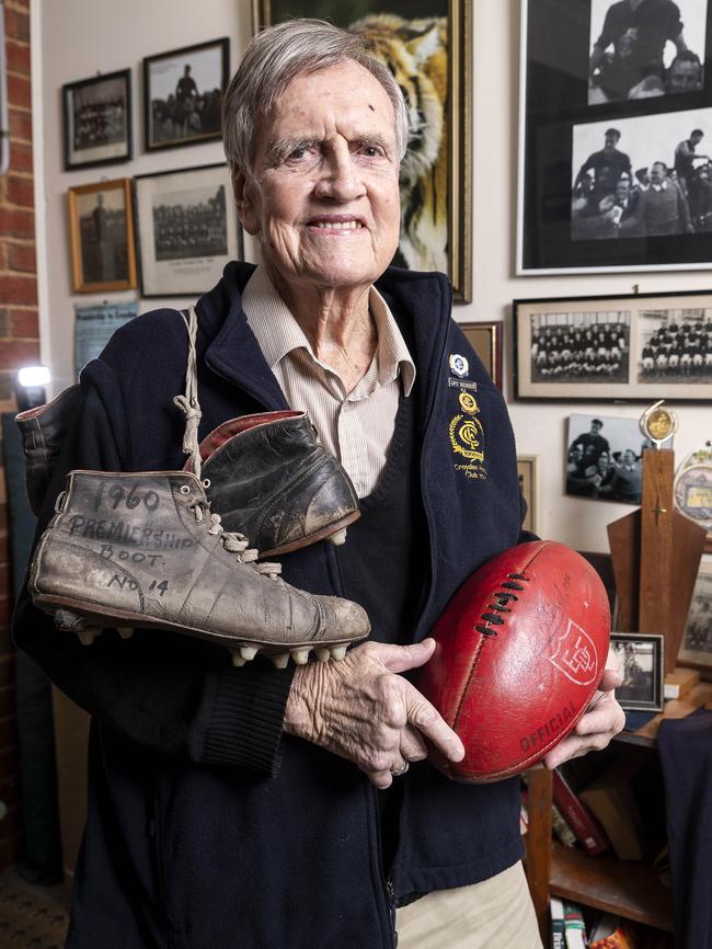 Roger O'Brien with the boots he wore in the 1960 grand final. Photo: Daniel Pockett