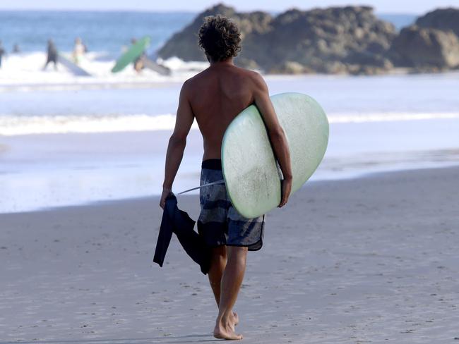 A surfer on the beach at Byron Bay. File image. Picture: Nathan Edwards