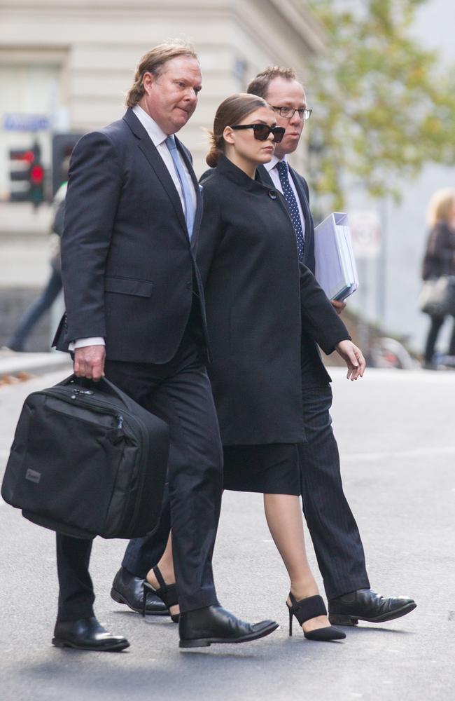 Belle Gibson pictured leaving court in Melbourne during a break in proceedings, accompanied by her lawyers. Picture: Matrix News