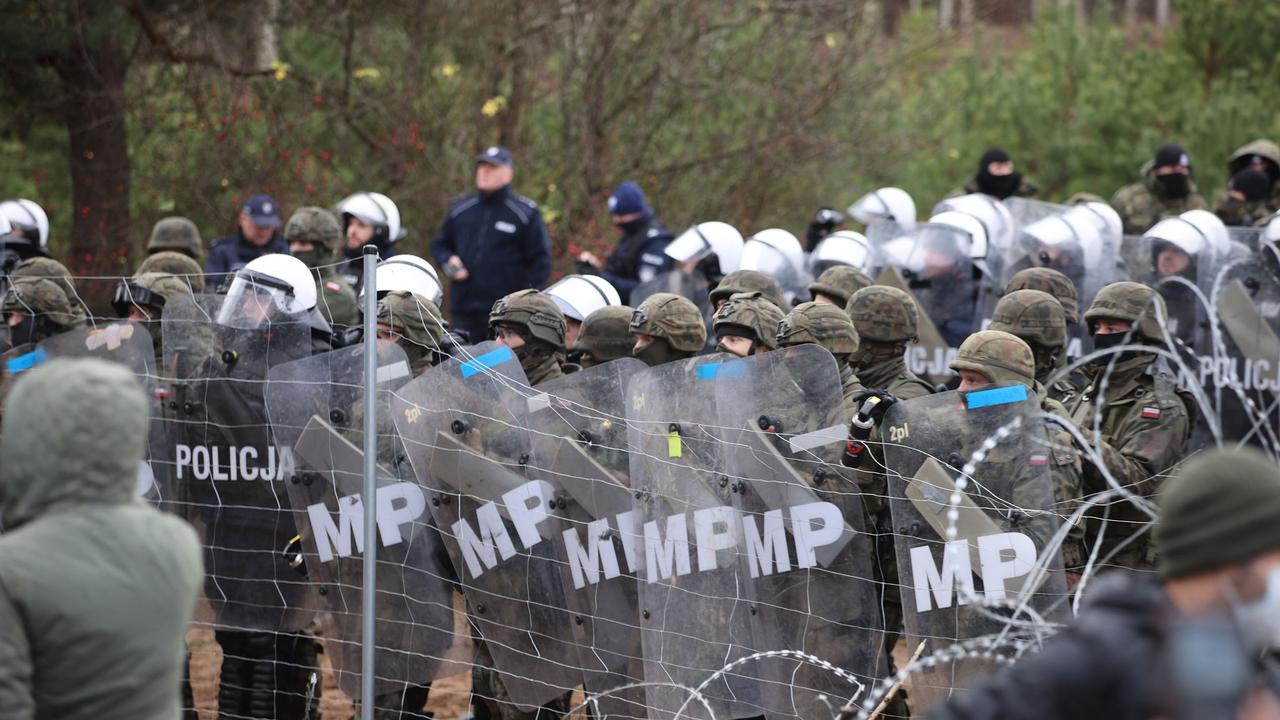 Poland's law enforcement officers watching migrants at the Belarusian-Polish border. Picture: Leonid Shcheglov/BELTA/AFP