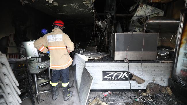 Fire Cause Investigators examine the scene. Picture: Tait Schmaal