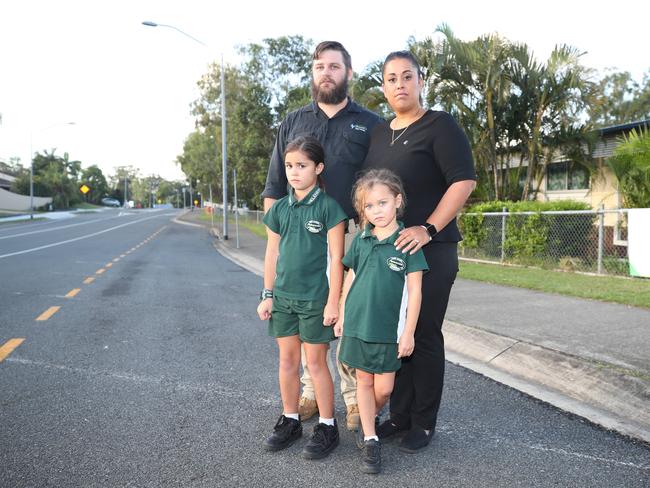 Andrew Hall and Suzanne Hall with their children Chloe, 8, and Georgia, 5, and at the ‘kiss and go’ zone outside Helensvale State School. Picture: Glenn Hampson.