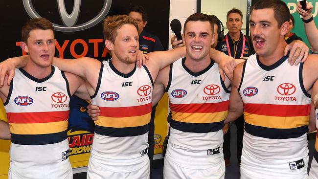 Matt Crouch, Rory Sloane, Brad Crouch and Taylor Walker sing the club song after beating St Kilda in April. Picture: Quinn Rooney/Getty Images