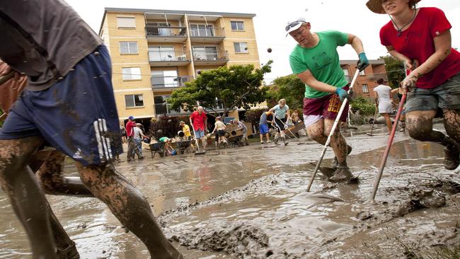 Residents and volunteers work together to clean up the homes and streets of the West End area of Brisbane.