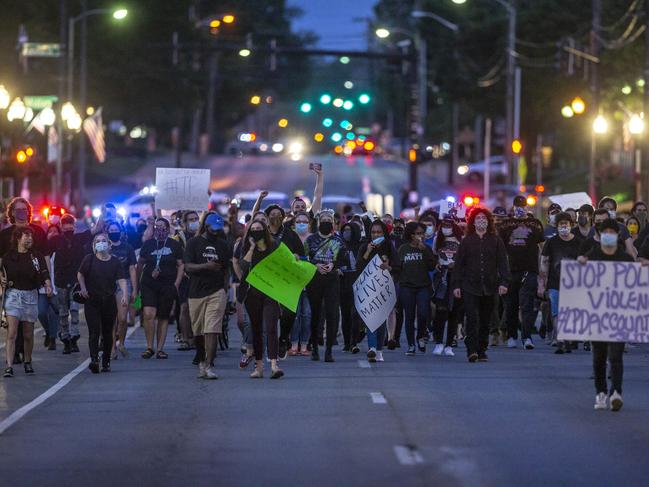 Protesters calling for an end to police violence walk through downtown Lexington, Kentucky. Picture: Ryan C. Hermens/Lexington Herald-Leader via AP