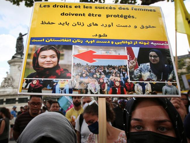 A woman holds a placard reading "Rights and success of women should be protected" as she takes part in a rally in support of Afghanistan's women in Paris. Picture: AFP