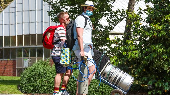 A man is seen pushing a beer keg at the Royal Botanic Gardens.