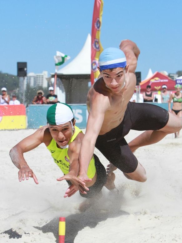 Tynan Neveceral, left, and Peter Thoroughgood, right, battling in the Australian beach flags race at the 2019 Aussies. Pic: Harvie Allison.