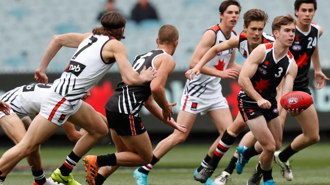 Taj Schofield gets a handball away in the Under-17 All Stars game last year. Picture: AFL Photos via Getty Images