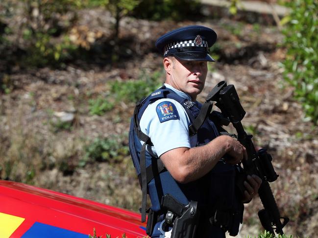 An armed officer outside Brenton Tarrant’s house. Picture: Gary Ramage