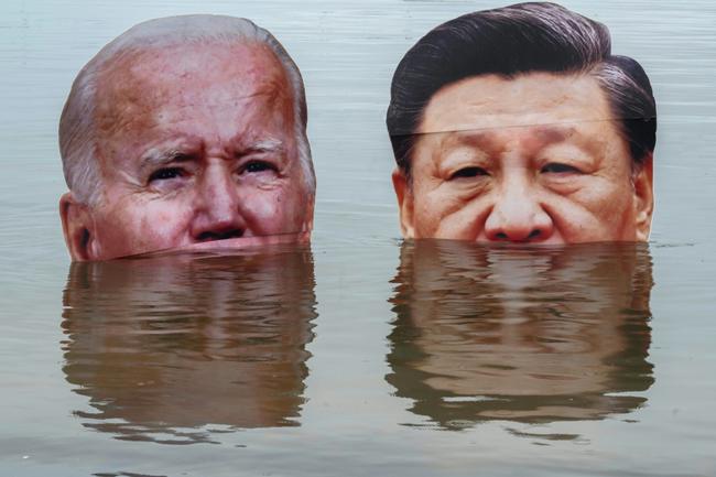 Portraits of US President Joe Biden and China President Xi Jinping are submerged by indigenous people in Rio de Janeiro, Brazil to protest what they say is lack of leadership on addressing the climate and biodiversity crisis