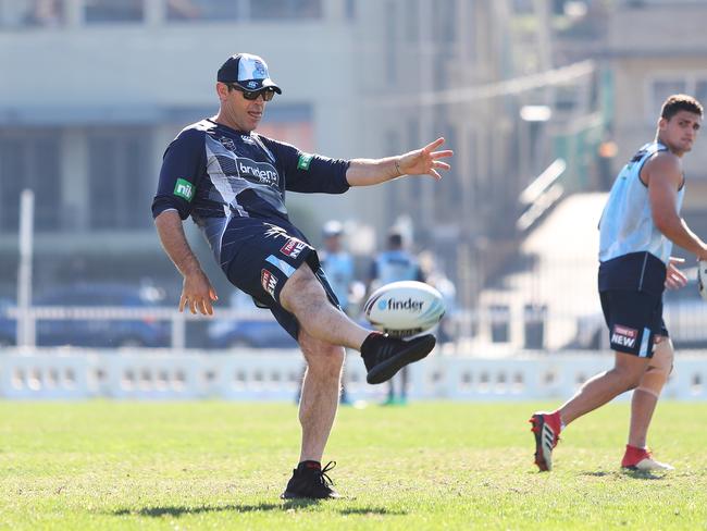 NSW coach Brad Fittler kicks a ball as Nathan Cleary looks on. Picture: Brett Costello