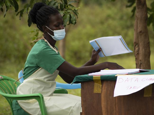 Nakanyike Victor, a registered nurse, attends to a data entry point during the COVID-19 vaccination of health workers at Namatale Health Centre III, Namatale Island, Uganda. Picture: UNICEF