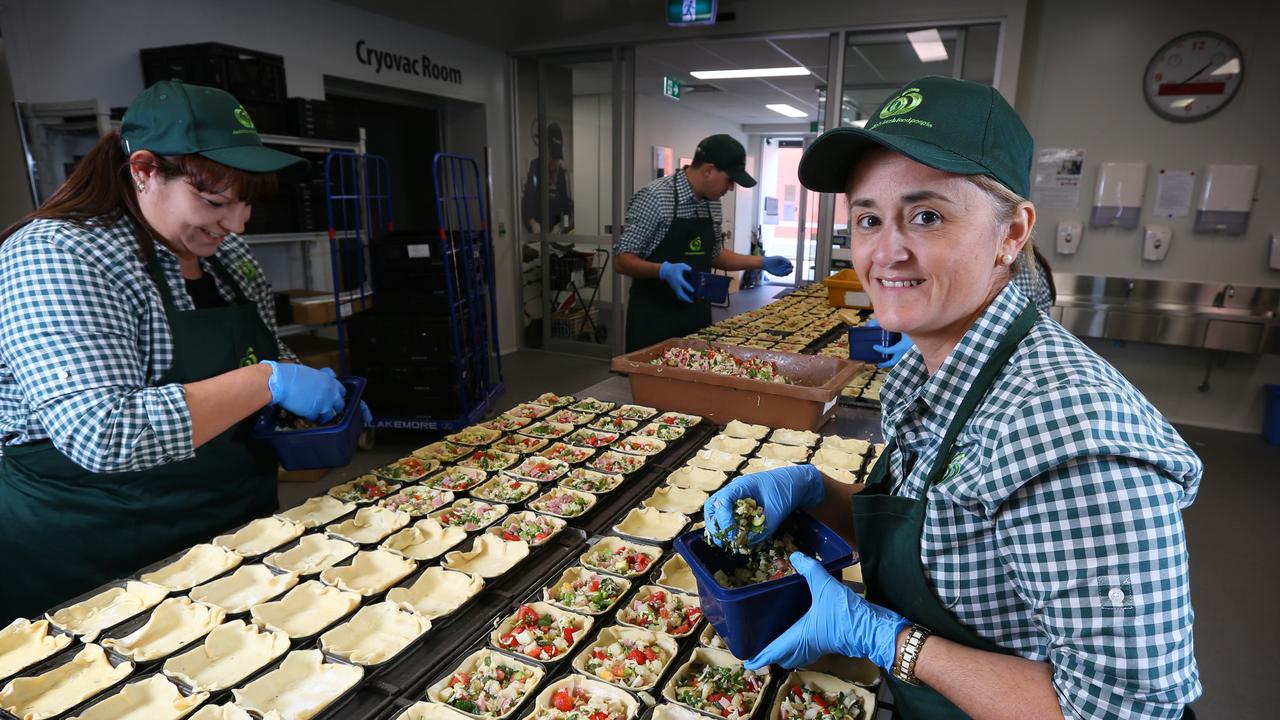 Woolworths support staff donating their time to cook in FareShare's kitchen