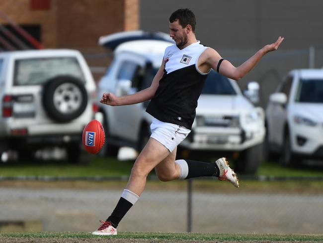 Ben Power gets a kick away for Ringwood. Picture: James Ross/AAP