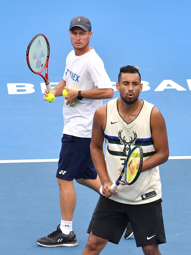 Hewitt (L) watches Kyrgios during training. Picture: AAP/Darren England