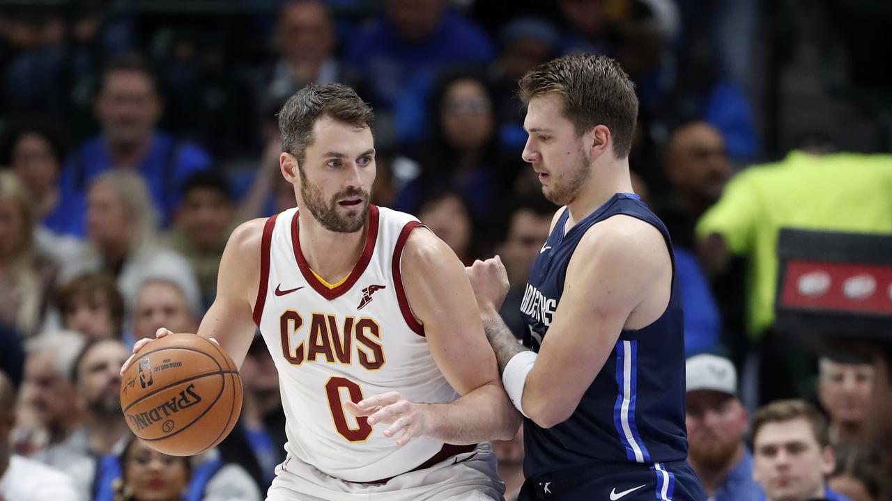 Cleveland Cavaliers forward Kevin Love (0) works against Dallas Mavericks forward Luka Doncic (77) for a shot opportunity in the first half of an NBA basketball game in Dallas, Friday, Nov. 22, 2019. (AP Photo/Tony Gutierrez)