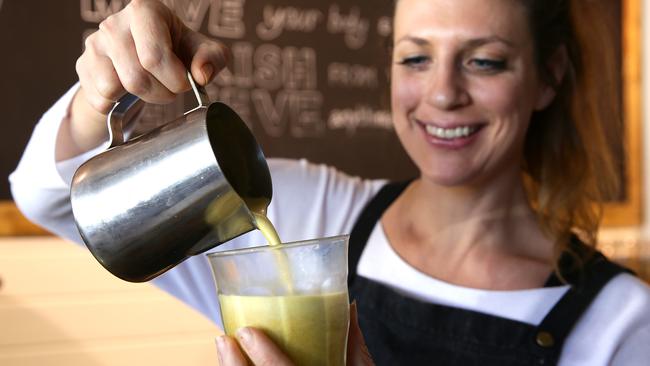 Tahlia Hailes pours a turmeric latte at Greenhouse Gypsy.