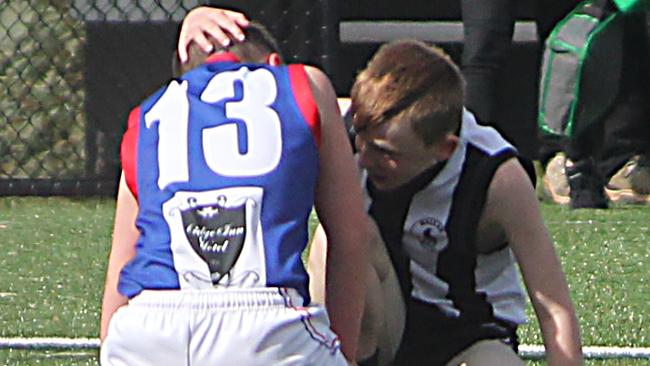 Logan Kemp consoles Mernda opponent Liam Michael before joining his team’s celebrations.