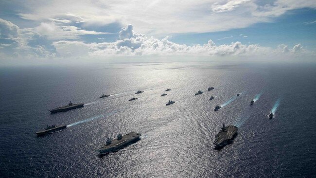 HMS Queen Elizabeth aircraft carrier and America’s USS Ronald Reagan and USS Carl Vinson in waters southwest of Okinawa at the weekend. Picture: Royal Navy