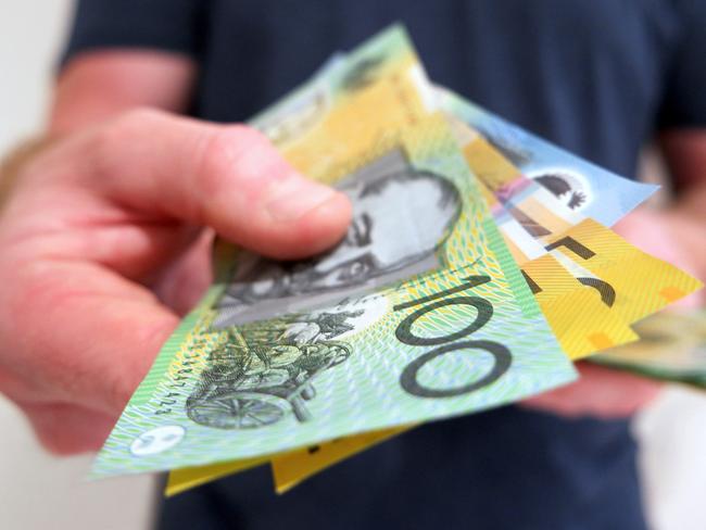 A man handing out Australian dollar bills. A picture that describes buying, paying, handing out money, or showing money.