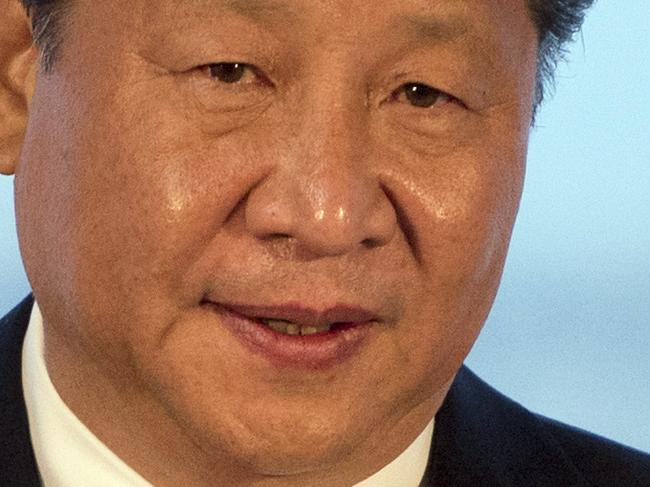 Chinese President Xi Jinping addresses an audience of dignitaries including the British Prime Minister David Cameron at Manchester airport in Manchester, England, Friday Oct. 23, 2015. Although there were protests at several venues throughout his stay, the carefully orchestrated visit served Britain's Prime Minister David Cameron's goal of emphasizing the important of Britain's developing economic relationship with China. (Oli Scarff / Pool via AP)