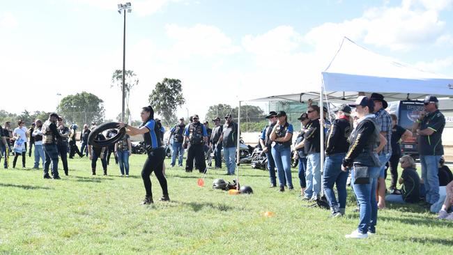 A female competitor prepares to trow a motorcycle tyre in the Rockynats HOG games tyre toss. Picture: Jann Houley