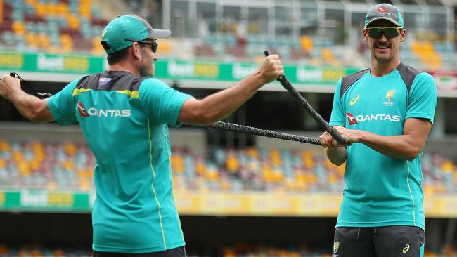 Chadd Sayers and Mitchell Starc warm up at the Gabba.