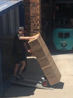 A staff member unloads a container. Picture: PFM