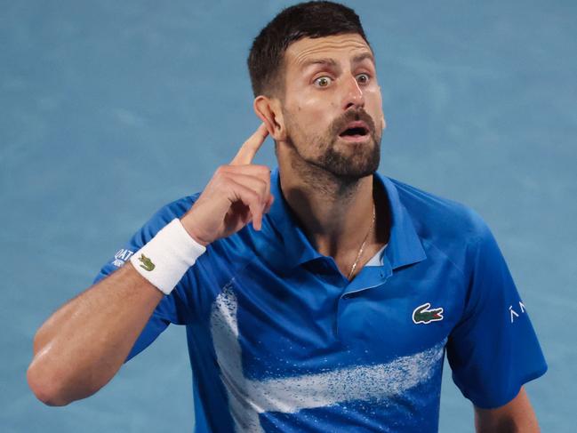 TOPSHOT - Serbia's Novak Djokovic gestures to the crowd after winning the third set during his men's singles quarterfinal match against Spain's Carlos Alcaraz on day ten of the Australian Open tennis tournament in Melbourne on January 21, 2025. (Photo by DAVID GRAY / AFP) / -- IMAGE RESTRICTED TO EDITORIAL USE - STRICTLY NO COMMERCIAL USE --