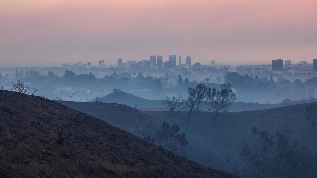 Burned trees from the Palisades Fire are seen from Will Rogers State Park, with the City of Los Angeles in the background amid a powerful windstorm on January 9, 2025 in the Pacific Palisades neighborhood of Los Angeles, California. (Photo by Apu Gomes / GETTY IMAGES NORTH AMERICA)