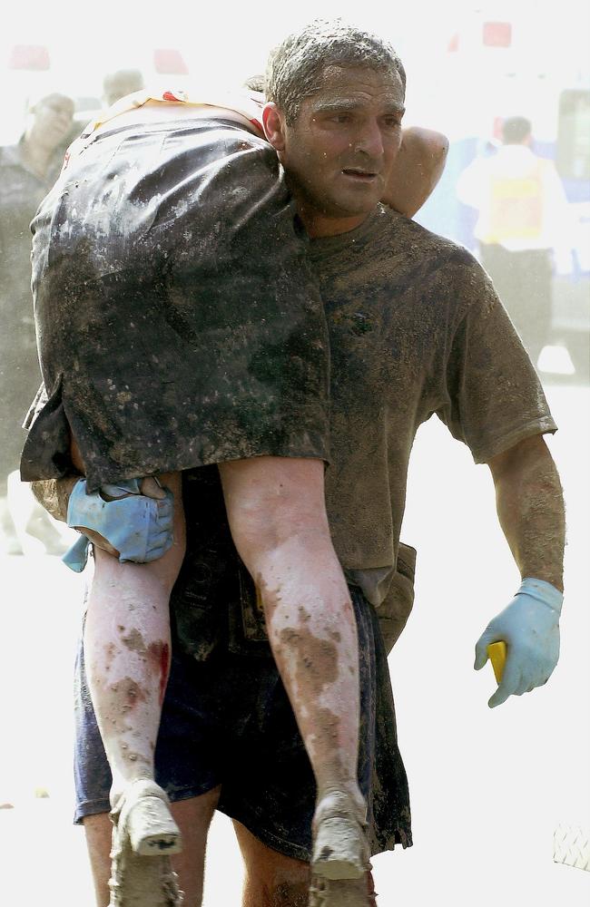 Secret Service agent Thomas Armas carries an injured woman to an ambulance after Tower One of the World Trade Centre collapsed. Picture: Thomas Monaster/NY Daily News Archive via Getty Images