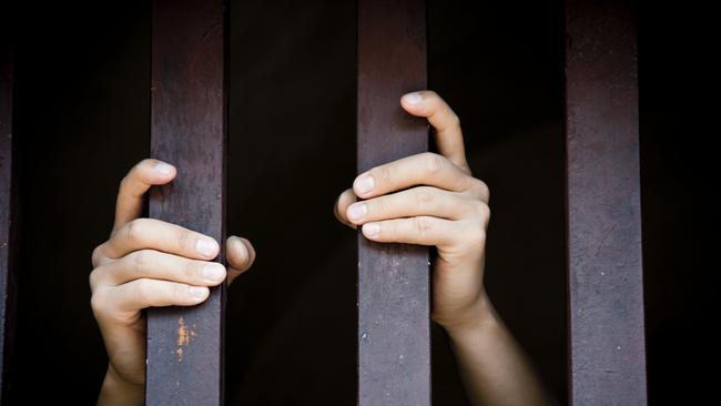 Prisoner, hands holding bars, jail, behind bars, children behind bars, asylum seeker generic, detention center, detained, jailed, shame, sadness, mental health, restriction, limitation generic, thinkstock