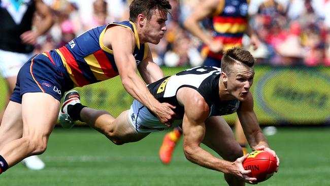 AFL - Showdown 40 - Adelaide Crows v Port Adelaide at Adelaide Oval. Robbie Gray under pressure from Paul Seedsman. Picture: Sarah Reed.