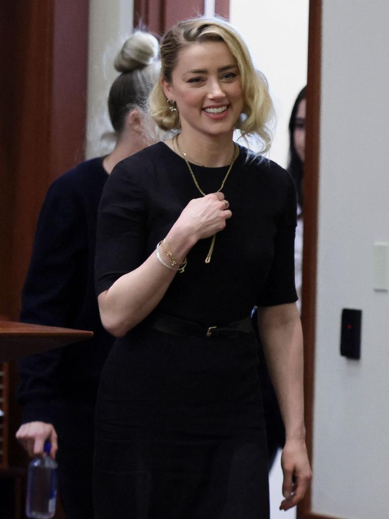 Amber Heard was all smiles on her way in to court. (Photo by EVELYN HOCKSTEIN / POOL / AFP)