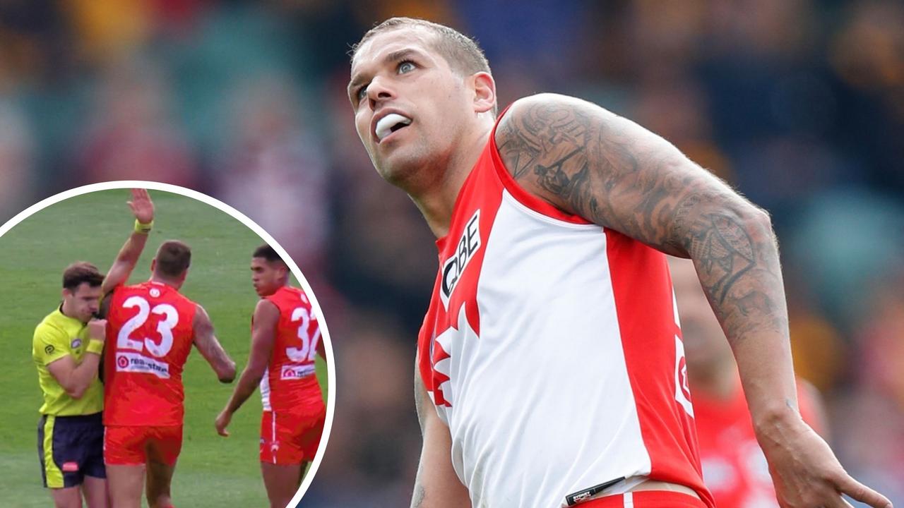 Lance Franklin makes contact with umpire Paul Rebeschini.