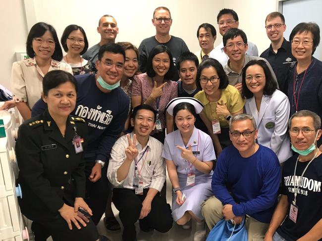 Dr Richard Harris and his diver partner, Craig Challen, with medical staff caring for the rescued children in Chang rai hospital. Picture: Supplied