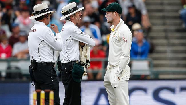 Cameron Bancroft is questioned by umpires Richard Illingworth (left) and Nigel Llong during the Cape Town Test. Picture: AFP