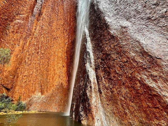 More than 22mm of rain fell, causing rock holes to overflow and gushing waterfalls down the sides of Uluru and Kaṉtju Gorge. Picture: Parks Australia/Ranger Meegan