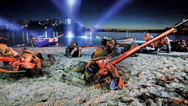 Mark McDonald lays on the sand during the re-enactment. Pic by Luke Marsden.