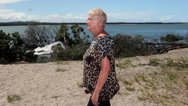 Caravan owner Jenny Gass walks past the sunken remains after a caravan got swallowed by a sinkhole. picture: Glenn Barnes