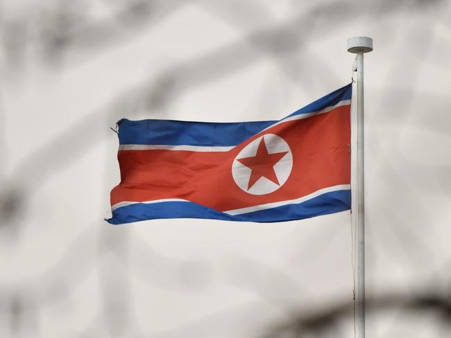 The North Korean flag flies above the North Korean embassy in Beijing on March 28, 2018.  North Korean leader Kim Jong Un was given a lavish welcome by Chinese President Xi Jinping during a secretive trip to Beijing as both sides seek to repair frayed ties before Pyongyang's landmark summits with Seoul and Washington. / AFP PHOTO / Greg Baker