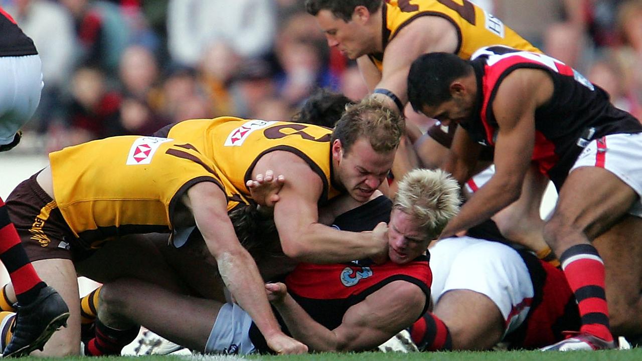 Hawthorn's Richard Vandenberg punches Essendon's Adam McPhee. Picture: Ryan Perse/Getty Images