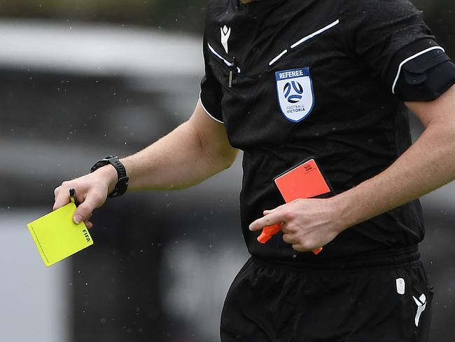 NPL VIC Men, Round 2, Avondale FC vs Port Melbourne Sharks SC, played at Avenger Park, Parkville, Victoria, Saturday 15th February 2025. Match referee holding a yellow card. Picture: Andrew Batsch